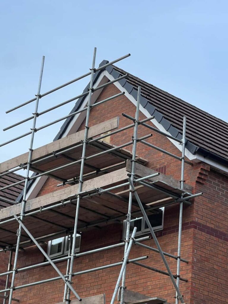 This is a photo of a roof which has just been repaired. There is a scaffold located at the gable end for access onto the roof. Works carried out by LS Roofing Great Missenden
